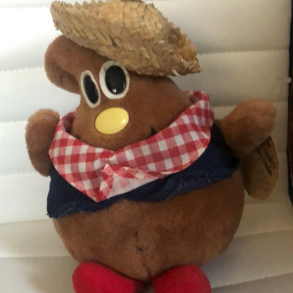 Vintage stuffed nestle morsel dressed with straw hat and scarf